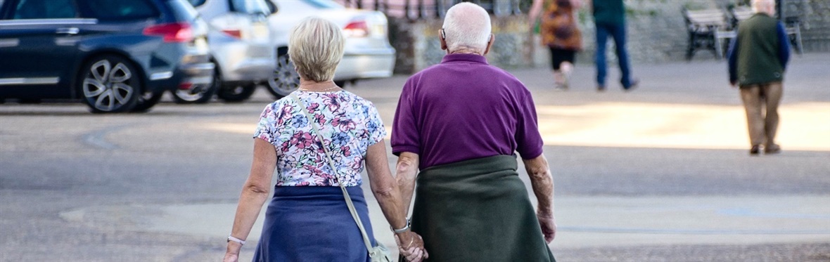 Older couple walking down the street